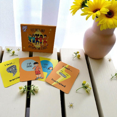 Set of feeling cards on a wooden surface with flowers in the background