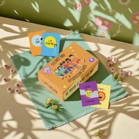 Set of affirmation cards on a green fabric with floral decorations